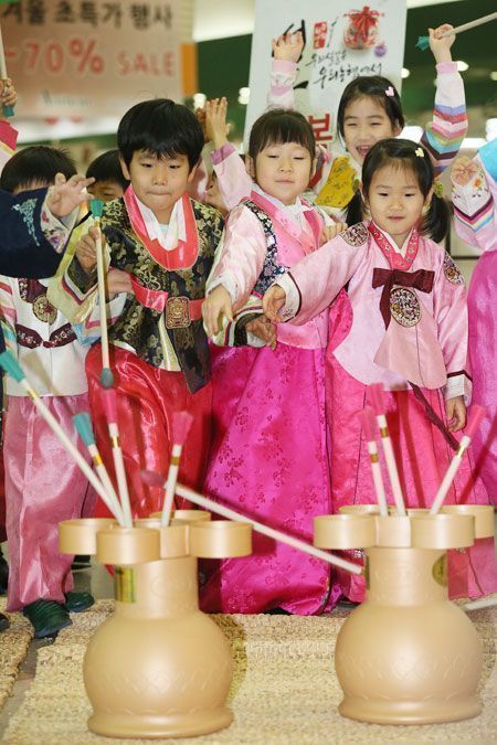 Playing traditional game - The Korea Times