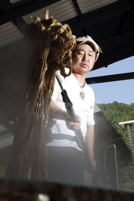 Korean hanji artisan Jang Seong-woo scooping mulberry pulp with a bamboo screen at his Jangjibang workshop in Gapyeong, fourth-generation hanji maker