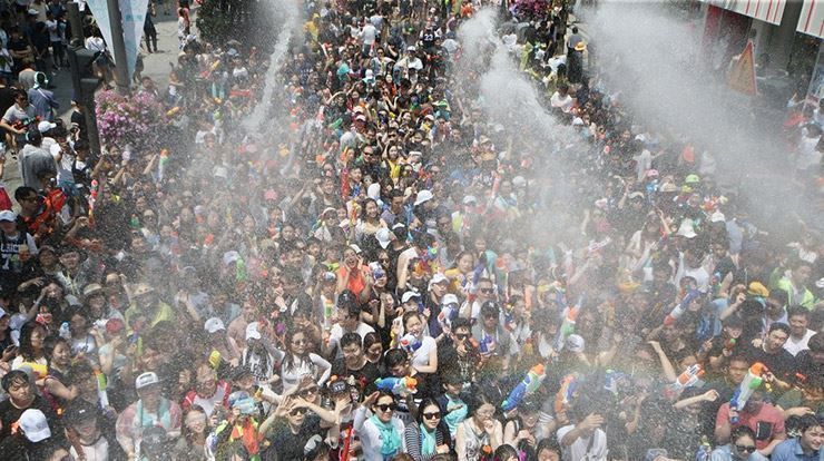 Robotic water cannons spraying festival crowd from a tower at the Sinchon Water Gun Festival
