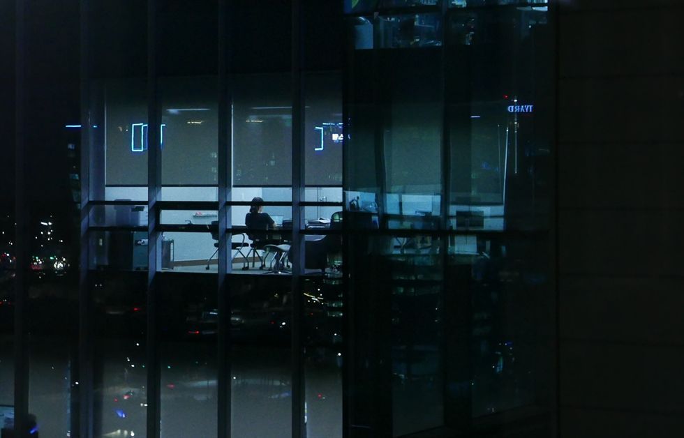 Pangyo Techno Valley in Seongnam, Gyeonggi Province, at night, showing offices lit late as software engineers work overtime