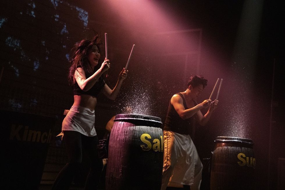 Actors performing Nanta the non-verbal cooking-themed percussive Korean show at the dedicated Myeongdong Nanta theater in Seoul demonstrating drumming with kitchen knives on cutting boards