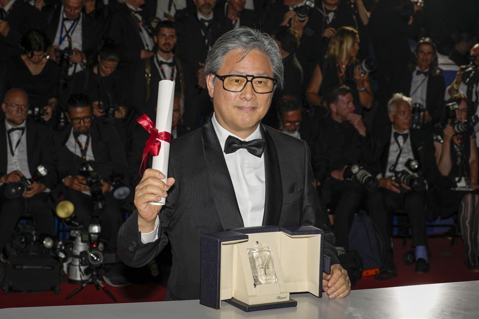 Director Park Chan-wook poses with the Best Director trophy for Decision to Leave at the 75th Cannes Film Festival