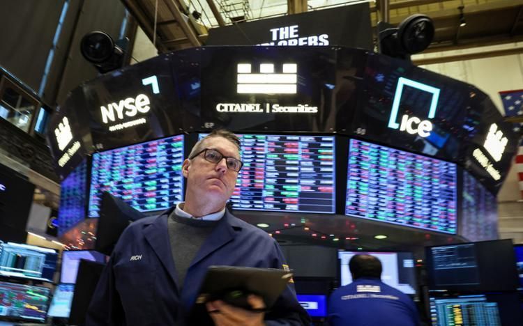 Dow hits a record as Wall Street rallies after Fed signals rate cuts in ...