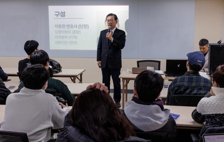 Embattled president rallies young conservatives to influence trial